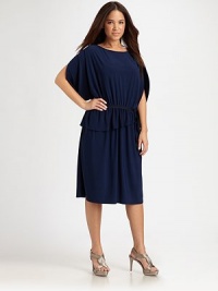 Simply sophisticated, this design has it all: an alluring neckline, flattering arm coverage, comfortable elasticized waist and a fashion-forward asymmetrical hem.Round necklineShort sleevesElasticized waistAsymmetrical hemAbout 27 from natural waist96% polyester/4% elastaneDry cleanImported