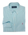 A trim-fitting long-sleeved shirt is crafted from silky cotton poplin in a bold striped pattern.