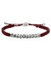 Summer-ready color from Fossil. This playful design features detailed beads with glistening clear crystal accents for a unique take on the classic woven bracelet. An adjustable red braided cotton cord holds it all together. Set in silver tone mixed metal. Approximate diameter: 2-1/2 inches.