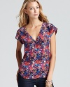 A multi-colored bouquet of blooming flowers enrich this printed Joie top with pure and unabashed femininity.