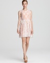 A melon hue peeks out from underneath pale metallic lace on this shimmering ERIN Erin Fetherston dress.