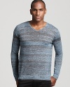 Muted gray and light blue stripes add depth to a fashion-forward slim fit sweater from Theory.