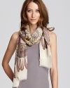 A charming scene of colorful birds and geometric patterns decorate this cozy wool scarf from Inoui.