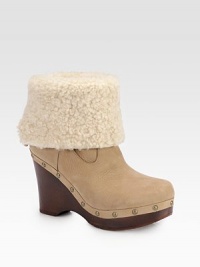 An on-trend leather essential featuring a plush shearling cuff, wooden heel and edgy metal studs. Wooden heel, 4 (100mm)Wooden platform, 1¼ (30mm)Compares to a 2¾ heel (70mm)Leather and shearling upperShearling liningRubber solePadded insoleImported