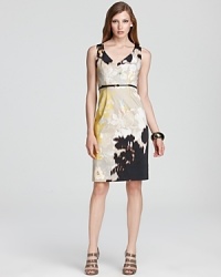 Graphic floral prints burst from the sleek silhouette of this Elie Tahari dress, while a yellow and black print make for an edge of urban attitude.