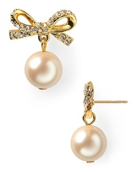 A pair of prim and proper pearls dangle oh-so delicately from crystal-bedecked posts on these kate spade new york stud earrings.