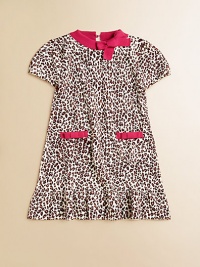 Here's the spot for a wild and fun animal print in a soft, sweater-y knit with bright contrast trim.Contrast ribbed crew neckline with bowShort sleeves with elasticized cuffsKeyhole button back closeFront patch pockets with contrast bow trimA-line shapeRuffled hemRamie/cottonMachine washImported