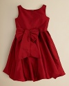 An on-trend bubble dress in bright red sateen with a sash and bow at the hip.