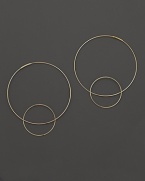 Like magic, smaller hoops balance on 14K gold counterparts.