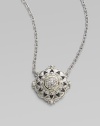 From the Windsor Collection. A lacy medallion combining graphic shapes, delicate granulation and the sparkle of white sapphires hangs from a graceful chain of textured links. White sapphires Sterling silver and 18k yellow gold Chain length, about 17 Pendant diameter, about 1 Lobster clasp Imported