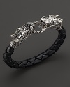 Bold sterling silver dragons link a length of braided leather. From the John Hardy Naga Collection.