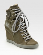 Lace-up leather hi-top sneakers revitalized by soft suede trim and a towering wedge. Self-covered wedge, 3¼ (80mm)Leather and suede upperLeather liningRubber solePadded insoleImportedOUR FIT MODEL RECOMMENDS ordering one half size up as this style runs small. 