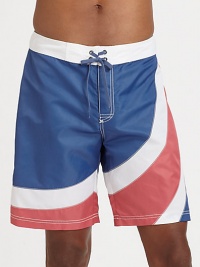 A summer favorite, for the beach and beyond, brightly designed in quick-drying nylon for maximum comfort and support.Drawstring tie waistBack flap pocketInseam, about 9NylonMachine washImported