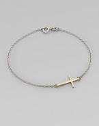 A simple, sleek cross of 14k gold sits sideways within a delicate sterling silver chain in this eloquent design.14k yellow gold and sterling silverLength, about 7Spring ring claspMade in USA