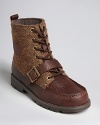 A rugged work boot is embellished with a herringbone fabric upper, soft lining and buckle strap detail above the toe.