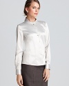 Chic color blocking and pleated contrast cuffs infuse the classic T Tahari blouse with cool new attitude.