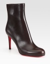 Shapely leather bootie with back seam detail and sculpted stiletto.Self-covered heel, 3½ (90mm) Shaft, 5¼ Leg circumference, 9½ Round toe Inside zip Leather lining Padded insole Signature red leather sole Made in ItalyOUR FIT MODEL RECOMMENDS ordering one half size up as this style runs small. 