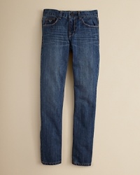 A medium wash skinny jean with fading and whiskering accents and pronounced topstitching at the seams.