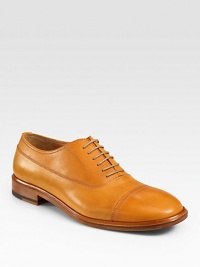 An extraordinary oxford design gets a modern update, rendered in a smooth, vibrant leather with stitching and captoe detail.Leather upperLeather liningPadded insoleLeather soleMade in Italy