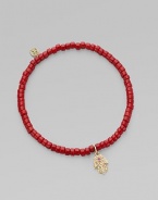 The hamsa, a traditional protective amulet, is encrusted with diamonds and accented with one ruby as it hangs from a stretchy strand of richly colored coral beads. Diamonds, 0.05 tcw Coral 14k yellow gold Diameter, about 2 (unstretched) Charm length, about ½ Imported