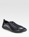 Polished, calfskin leather lace-up design with cap-toe detail and logo-embossed rubber sole for added comfort and support.Ankle pull tabLeather upperLeather liningRubber soleImported