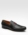 A slip-on design in superior leather with signature green/red/green web trim. Rubber sole Made in Italy 