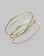 A simple, slender bangle of 18k gold has a stunning hammered texture that intriguingly catches and reflects light. 18k yellow gold Diameter, about 2½ Imported Please note: Bracelets sold separately.