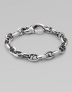 Bold oval links of polished sterling silver have not-so-sinister curved spikes in their centers.Sterling silver Length, about 8½ Lobster clasp Imported