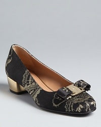 These incredibly elegant Salvatore Ferragamo pumps channel 17th century era, aristocratic touches, in tapestry lace with shining metallic heels. They are certainly fit for a queen.