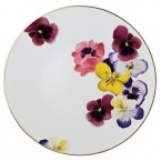 Pensees dinner plate by Bernardaud. This lively, luxurious plate is sure to transform your table into a celebration of spring. The floral watercolor pattern features delicate, multicolored pansies that appear to be strewn across the surface of each piece.