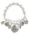 Take a shine to this half stretch bracelet from Kenneth Cole New York. Crafted from silver-tone mixed metal, glistening glass pearls and accents truly add luster to this piece. Item comes packaged in a signature Kenneth Cole New York Gift Box. Approximate diameter: 2-1/2 inches.