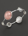 Alternating faceted stones in blush, clear quartz and mother-of-pearl bring a sweet flush to this sterling silver bangle.