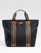 Cotton tote with signature web detail and leather trim. Zip top closure Double handles Leather bottom feet Includes detachable pouch with zip closure Interior zip, cell phone and PDA pockets 18W X 15H X 6D Made in Italy 