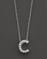 From the Tiny Treasures collection, a diamond C necklace. With signature ruby accent. Designed by Roberto Coin.