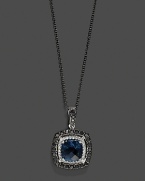 Black and white diamonds frame a faceted London blue topaz, set in 14K white gold with a rhodium chain.