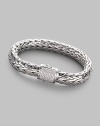 A rich woven chain of sterling silver with a barrel clasp of 18k white gold and pavé diamonds. Diamonds, 0.62 tcw Sterling silver and 18k white gold Length, about 7½ Width, about ¼ Push-lock clasp Made in Bali