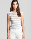 Armani Collezioni's versatile tee in neutral stripes is an off-duty essential. An asymmetrical hem adds a modern twist.