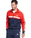 Sport solid athletic style and comfort in this track jacket from adidas.