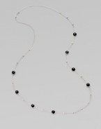 A long sterling silver chain with hammered bead and faceted onyx stations.Onyx Sterling silver Length, about 38 Lobster clasp closure Imported 