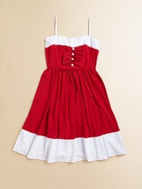 An eye-catching colorblock design with ruffles and a full skirt make this fancy frock the ultimate must-have.Sweetheart necklineAdjustable spaghetti strapsPullover styleRuffled ribbon bodice with button detailFull skirt92% polyester/8% spandexHand washMade in the USA of imported fabric