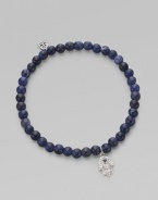 The hamsa, a traditional protective amulet, is encrusted with diamonds and accented with one sapphire as it hangs from a stretchy strand of deep-toned sodalite beads. Diamonds, 0.05 tcw Sodalite 14k white gold Diameter, about 2 (unstretched) Charm length, about ½ Imported