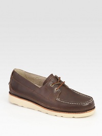 Crafted with boat-shoe inspired styling, this casual comfort essential is highlighted by contrast rubber sole and stitching.Leather upperLeather liningPadded insoleRubber soleImported