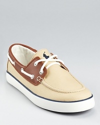 With a khaki canvas upper and leather trim, this handsome boat shoe embodies Ralph Lauren's heritage style.