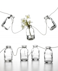 Garden garland. Mini glass bottles strung along a stainless steel wire offer a charming new way to spruce up backyard patios or casual kitchen decor. Personalize it with flowers, seashells or any number or colorful trinkets.