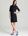 Slip on T Tahari's Avona dress, an effortless option in classic chambray and a cool, collarless silhouette.