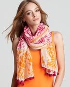 Add a bohemian accent to your favorite ensemble in an ikat printed scarf with contrast tassled ends.