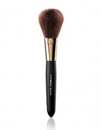 EXCLUSIVELY AT SAKS. An all purpose brush that glides soft and sensual against the skin for meticulous coverage. It provides a smooth even finish with a full dome shape assembled of sumptuous natural bristles, designed for applying pressed powder, loose powder and bronzing powder 