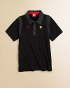 A classic polo shirt gets a dapper update with contrasting trim, unmistakeable Ferrari crest and embroidered Puma logo.Polo collarShort sleevesButton-frontCottonMachine washImported Please note: Number of buttons may vary depending on size ordered. 