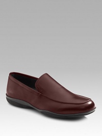 Soft calfskin slip-on has comfortable rubber sole with red stripe logo detail. Leather lining Padded insole Made in Italy 