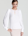 White hot and silky-soft, this BCBGMAXAZRIA blouse flaunts subtle puff sleeves and an alluring keyhole accent for a sophisticated look, rooted in elegant ease.